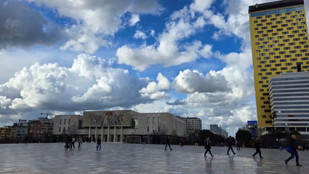  Pedestrians Cross Skanderberg Square in City Center Tirana, Albania.