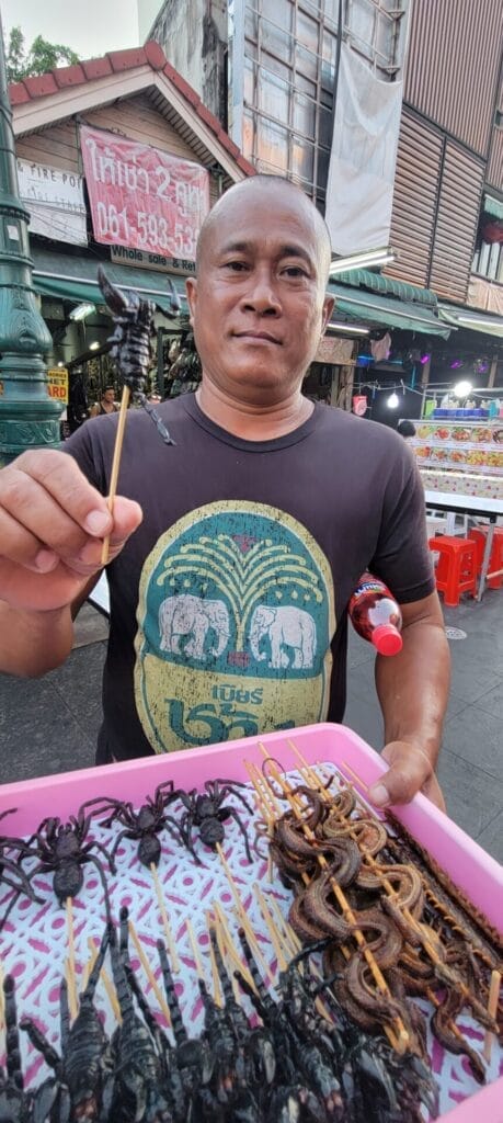 Vendor Selling Spiders, Snakes And Scorpions On A Stick in Bangkok