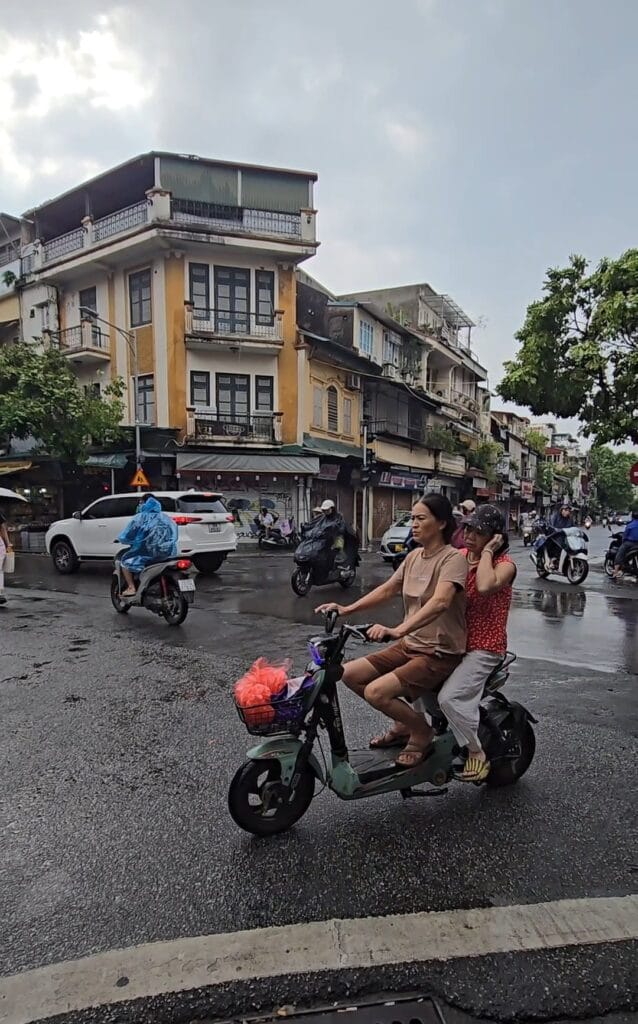 Cars going in every direction at an Hanoi Street corner