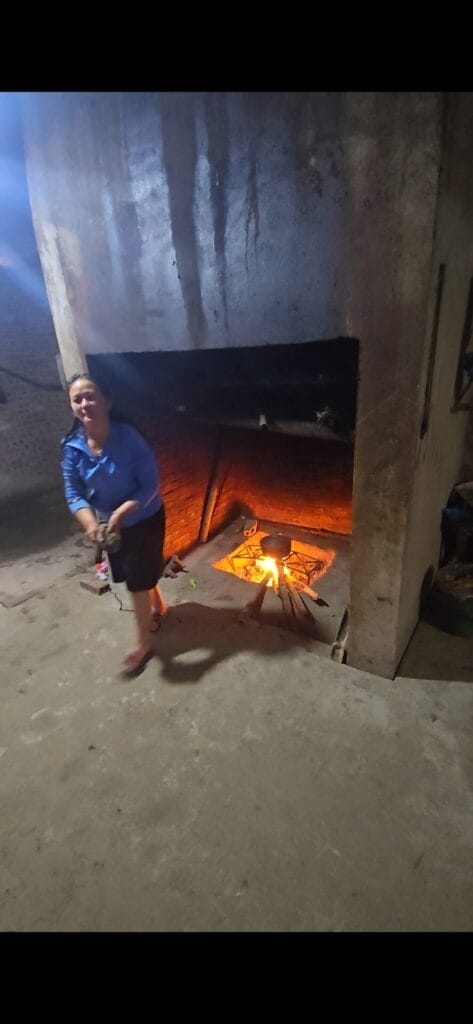 Zer Cooks on an Open Fire in Her Kitchen