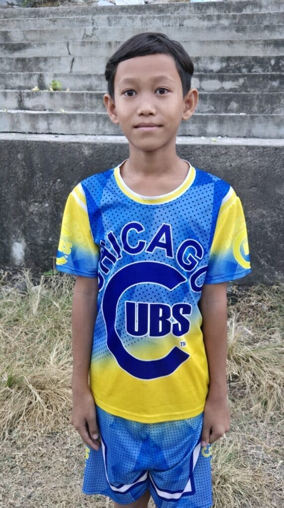 A Boy In Battembang, Cambodia Wearing a Chicago Cubs Shirt